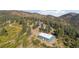 Aerial view of home and detached shop on a mountainside at 12421 High Country Trl, Littleton, CO 80127