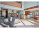 Open living space with fireplace and views from multiple windows at 12421 High Country Trl, Littleton, CO 80127