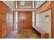 Bright entryway with tile floors and wooden doors and bench at 12421 High Country Trl, Littleton, CO 80127