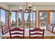 Bright dining room with a rustic table and chairs, offering stunning mountain views at 12421 High Country Trl, Littleton, CO 80127