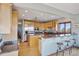 Spacious kitchen featuring light wood cabinets, granite countertops, and stainless steel appliances at 12421 High Country Trl, Littleton, CO 80127