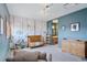 Charming Bedroom with a crib, dresser, and whimsical mural at 12421 High Country Trl, Littleton, CO 80127