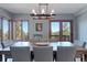 Spacious dining room with large windows, wooden table, and gray chairs, offering scenic views at 12421 High Country Trl, Littleton, CO 80127
