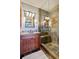 Spa-like bathroom with granite vanity, large walk-in shower, and updated fixtures at 12421 High Country Trl, Littleton, CO 80127
