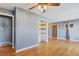 Living room with hardwood floors, built-in shelving and access to exterior at 1626 S Sheridan Blvd, Denver, CO 80232