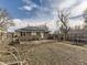 Back of house with solar panels and a spacious yard at 2095 S Knox Ct, Denver, CO 80219