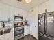 Modern kitchen with white cabinets, granite counters, and stainless steel appliances at 2095 S Knox Ct, Denver, CO 80219