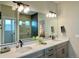 Double vanity bathroom with a large mirror reflecting a walk-in shower at 16707 Greyhawk Dr, Monument, CO 80132