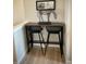 Modern breakfast bar with two black barstools for casual dining at 16707 Greyhawk Dr, Monument, CO 80132