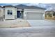 New construction home with gray siding, two-car garage, and landscaped front yard at 16707 Greyhawk Dr, Monument, CO 80132