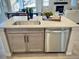 Modern kitchen island with quartz countertop, stainless steel sink, and dishwasher at 16707 Greyhawk Dr, Monument, CO 80132