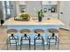 Modern kitchen with white cabinets, quartz countertops and island with four barstools at 16707 Greyhawk Dr, Monument, CO 80132