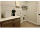 Functional laundry room with built-in shelving and a washer and dryer hookup at 16707 Greyhawk Dr, Monument, CO 80132