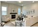 Spacious living room with a cozy fireplace and large windows offering natural light at 16707 Greyhawk Dr, Monument, CO 80132