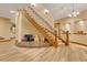 Elegant wooden staircase with wrought iron railing at 5230 Bow Mar Dr, Littleton, CO 80123