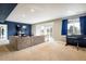 Finished basement with sectional sofa and large TV at 1366 Teton Pt, Lafayette, CO 80026