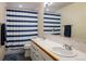 Bathroom with double vanity and striped shower curtain at 1366 Teton Pt, Lafayette, CO 80026
