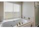 Bathroom with a large soaking tub and window at 1366 Teton Pt, Lafayette, CO 80026