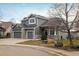 Two-story house with gray siding, three-car garage, and landscaping at 1366 Teton Pt, Lafayette, CO 80026