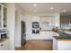 Bright eat-in kitchen with white cabinetry and double ovens at 1366 Teton Pt, Lafayette, CO 80026