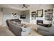 Living room with fireplace, built-in shelves, and large windows at 1366 Teton Pt, Lafayette, CO 80026