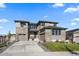 Two-story house with stone and wood siding, two car garage, and landscaped lawn at 7125 S Yantley Way, Aurora, CO 80016