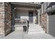 Inviting front porch with stone accents and a charming wreath on the door at 7125 S Yantley Way, Aurora, CO 80016