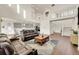 Open concept living room with high ceilings and a view of the kitchen and stairs at 7125 S Yantley Way, Aurora, CO 80016