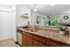 Kitchen with granite countertops, double sink, and dishwasher at 8813 Colorado Blvd # 207, Thornton, CO 80229