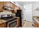 Galley kitchen with stainless steel appliances and granite countertops at 8813 Colorado Blvd # 207, Thornton, CO 80229