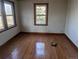 Empty bedroom with hardwood floors and large windows at 600 E 76 Ave, Denver, CO 80229