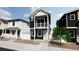 Two-story home with dark exterior, balcony, and light-colored accents at , Commerce City, CO 80022