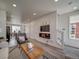 Open concept living room with fireplace and view into kitchen and dining areas at , Commerce City, CO 80022