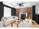 Living room features exposed brick wall, fireplace, and white sofa at 1473 Yates St, Denver, CO 80204