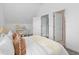 Bright bedroom with plush bedding and en-suite bathroom access at 1473 Yates St, Denver, CO 80204