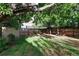Large backyard with spacious grass area, mature trees, and a shed at 1473 Yates St, Denver, CO 80204