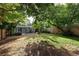 Backyard view of home with large trees and grassy area at 1473 Yates St, Denver, CO 80204