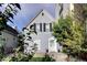 Gray shingle house with white door, landscaping, and a walkway at 1473 Yates St, Denver, CO 80204