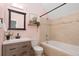 Bathroom with a tub, shower, and updated vanity at 1473 Yates St, Denver, CO 80204