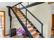 Modern metal staircase with wood steps leading to the upper level at 420 Chinook Rd, Idaho Springs, CO 80452