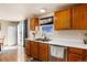 Kitchen with wood cabinets, double sink, and stainless steel appliances at 22381 E Oberlin Dr, Aurora, CO 80018