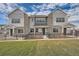 Front exterior of a two-story townhome with a fenced yard and attached garage at 27462 E 1St Ave, Aurora, CO 80018