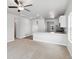 Open living room with neutral carpeting and a kitchen island at 914 Savona Ave, Fort Lupton, CO 80621