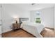 Bright bedroom featuring a queen bed, wood floors, and large window at 3575 Chestnut Pl # 704, Denver, CO 80216