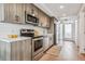Modern kitchen with stainless steel appliances and wood cabinets at 3575 Chestnut Pl # 704, Denver, CO 80216