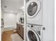 Modern bathroom with white subway tiles, a bathtub, and in-unit laundry at 3575 Chestnut Pl # 704, Denver, CO 80216