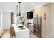 Modern kitchen with light wood cabinets, marble island, and stainless steel appliances at 4121 Kalamath St, Denver, CO 80211