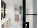Modern bathroom with double vanity, marble floors, and a large glass shower at 4121 Kalamath St, Denver, CO 80211