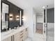 Modern bathroom with double vanity, marble floors, and a large glass shower at 4121 Kalamath St, Denver, CO 80211
