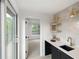 Modern wet bar with a sink, shelving and tile backsplash at 4121 Kalamath St, Denver, CO 80211